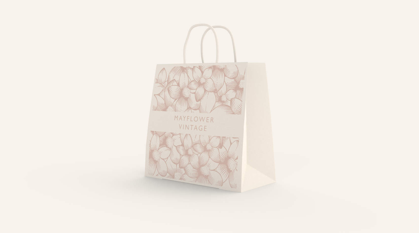 A paper shopping bag with a mayflower pattern and the words Mayflower Vintage printed on the side.