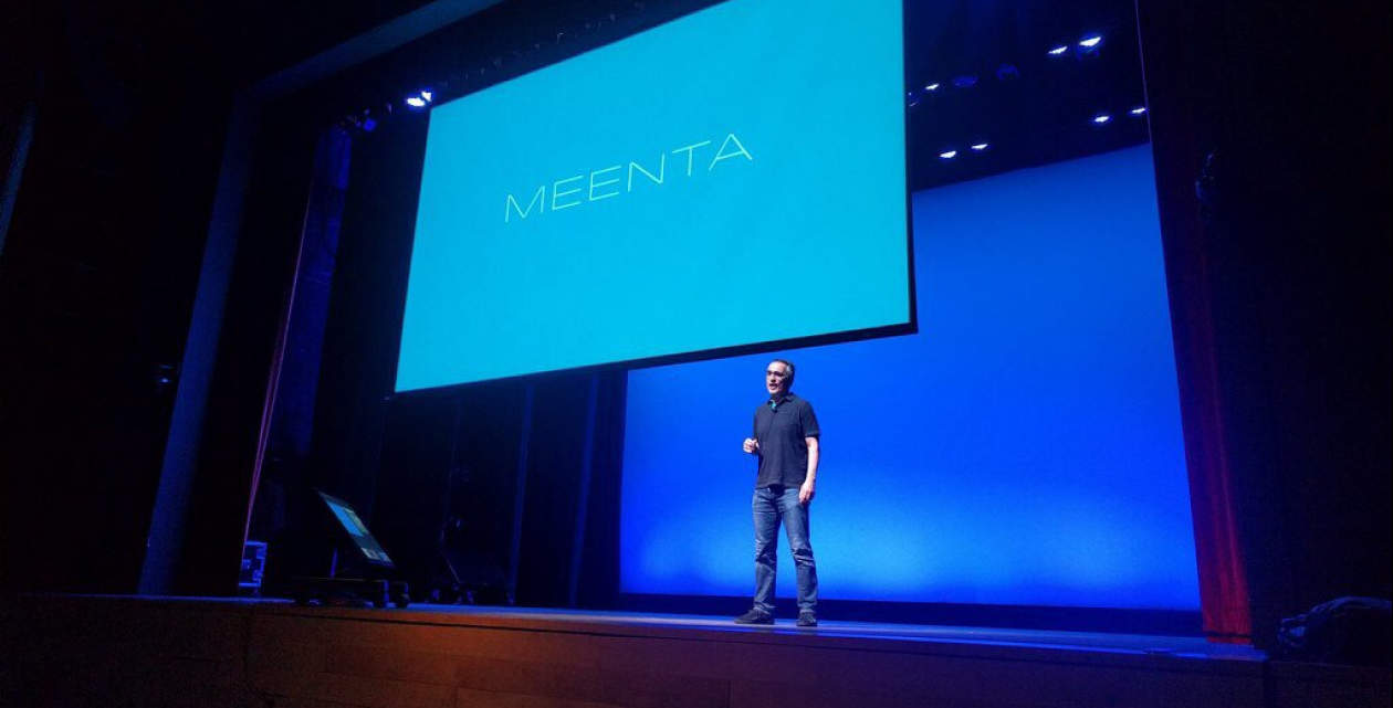 Photo of the Meenta CEO on the Techstars stage with slides presented behind him.
